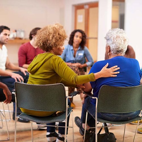 People Attending Self Help Therapy Group Meeting In Community Center